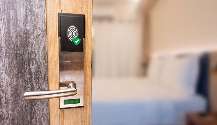 Security Sync: Advanced Home Protection Tech NJ; Fingerprint smart door system with bedroom background. Technology of security in hotel concept.