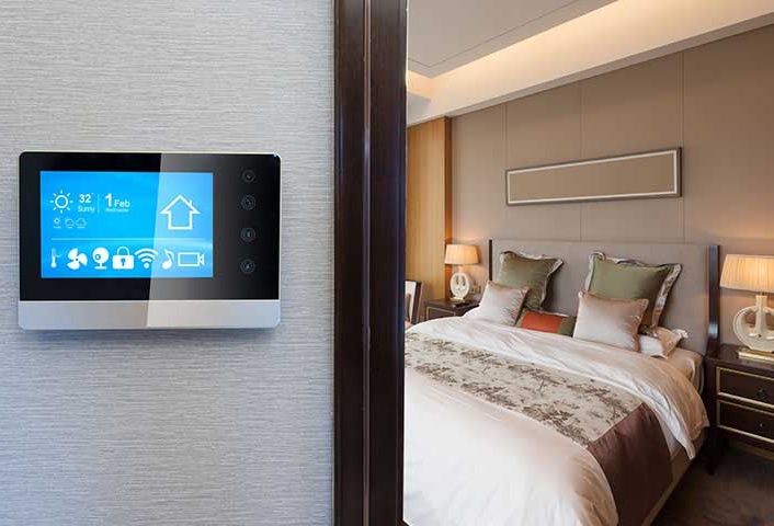 An Introduction To Home Automation NJ, smart screen on wall in modern luxury bedroom