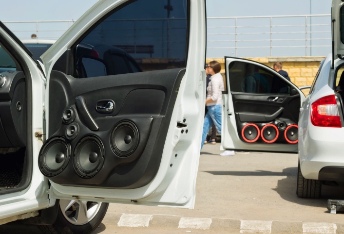 Custom car door panel fitted with multiple aftermarket speakers