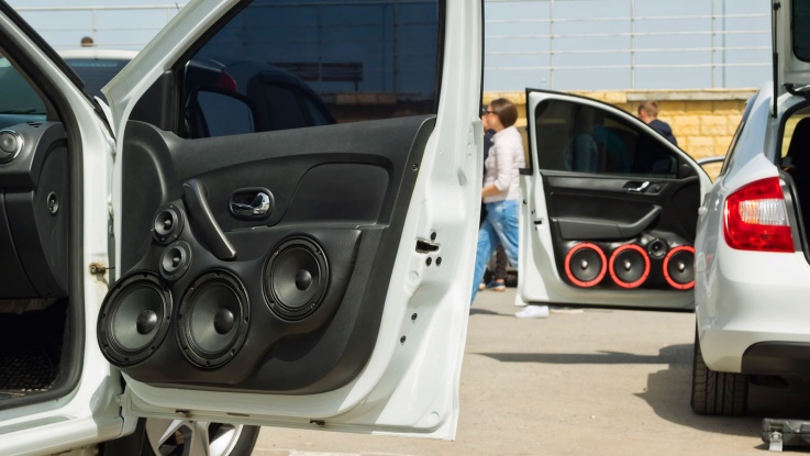 Custom car door panel fitted with multiple aftermarket speakers