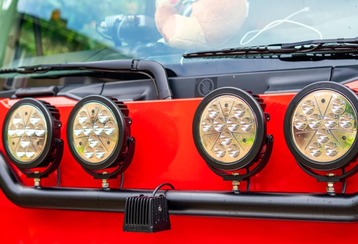 Off road LED light bar mounted on red vehicle bumper