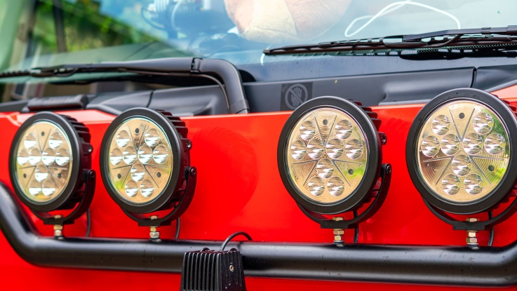 Off road LED light bar mounted on red vehicle bumper