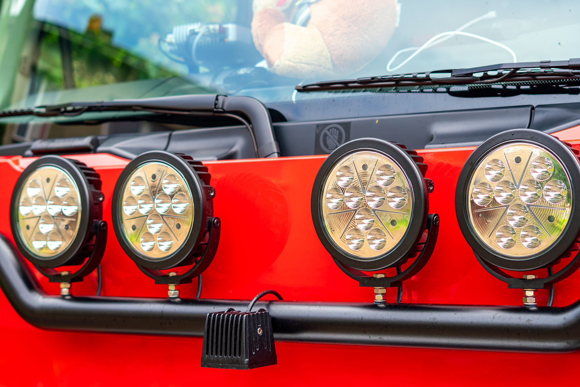 Off road LED light bar mounted on red vehicle bumper
